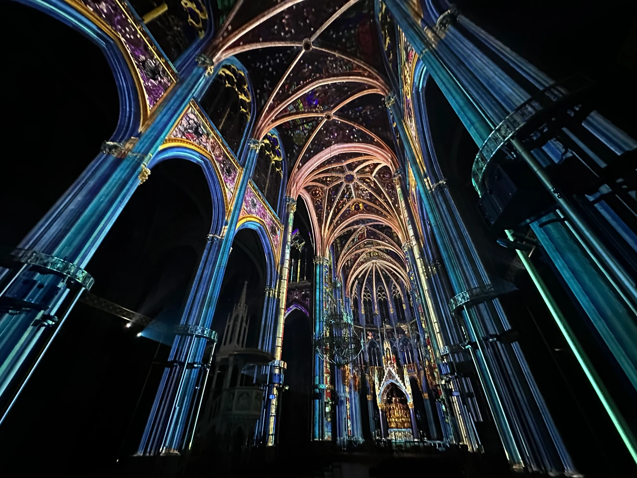 Blue and golden projections along the church vaults – LIGHT OF CREATION, Votivkirche, Vienna, Austria
