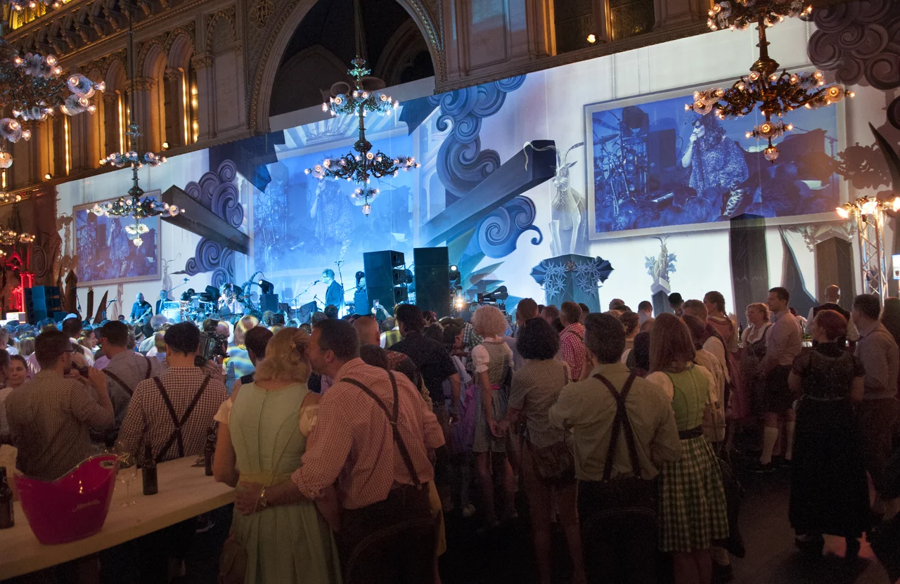 Blue stage and spatial projections above the ball audience – ALMDUDLER TRACHTEN-PÄRCHENBALL, City Hall, Vienna, Austria