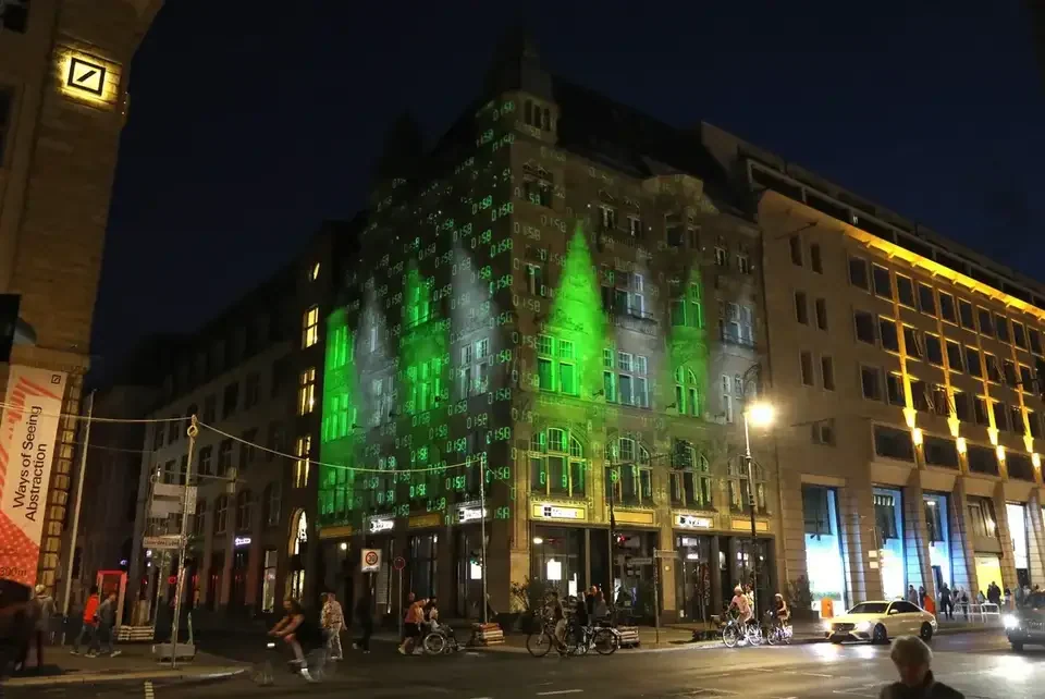 Grüne Fassadenprojektion auf ein mehrgeschossiges Gebäude – FESTIVAL OF LIGHTS, Berlin, Deutschland
