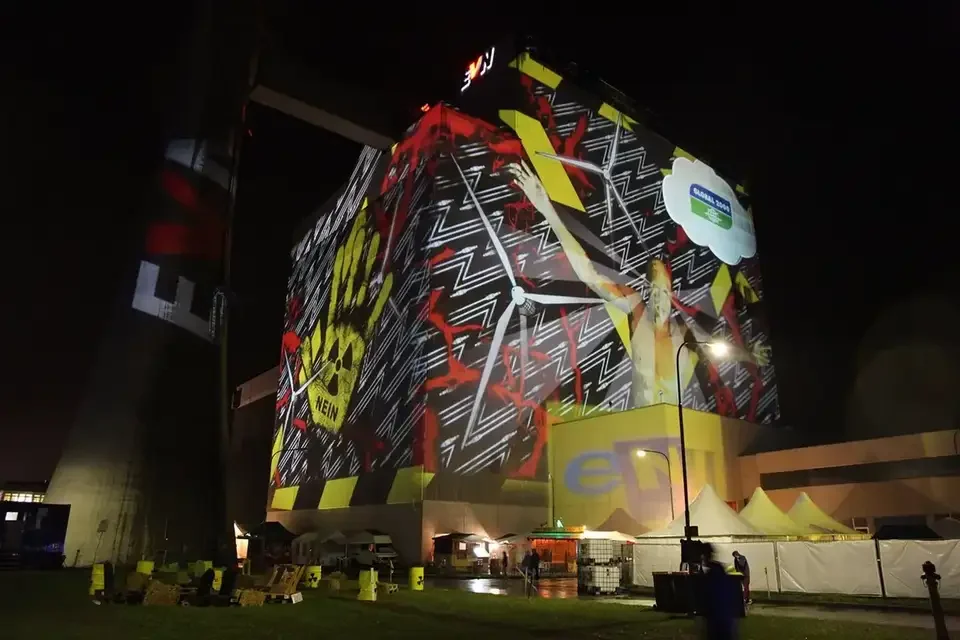 Bunte Bildcollage als Großbildprojektion auf ein Kraftwerksgebäude – TOMORROW FESTIVAL, Kernkraftwerk, Zwentendorf, Österreich