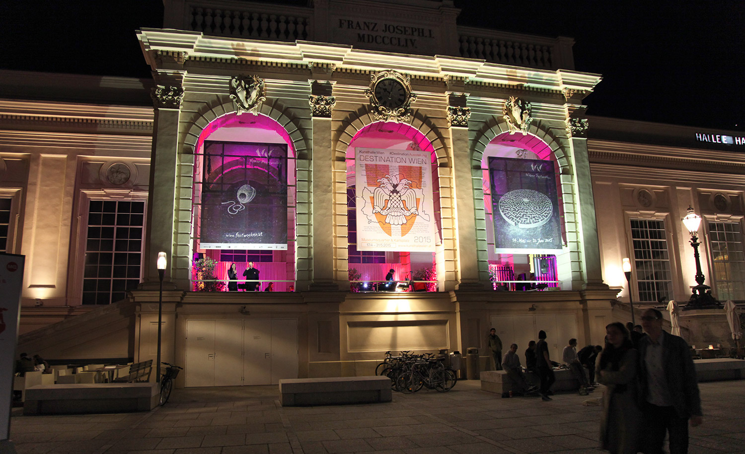 Pink projection imagery in three tall facade arches – MAGNUM PINK BLACK, MuseumsQuartier, Vienna, Austria
