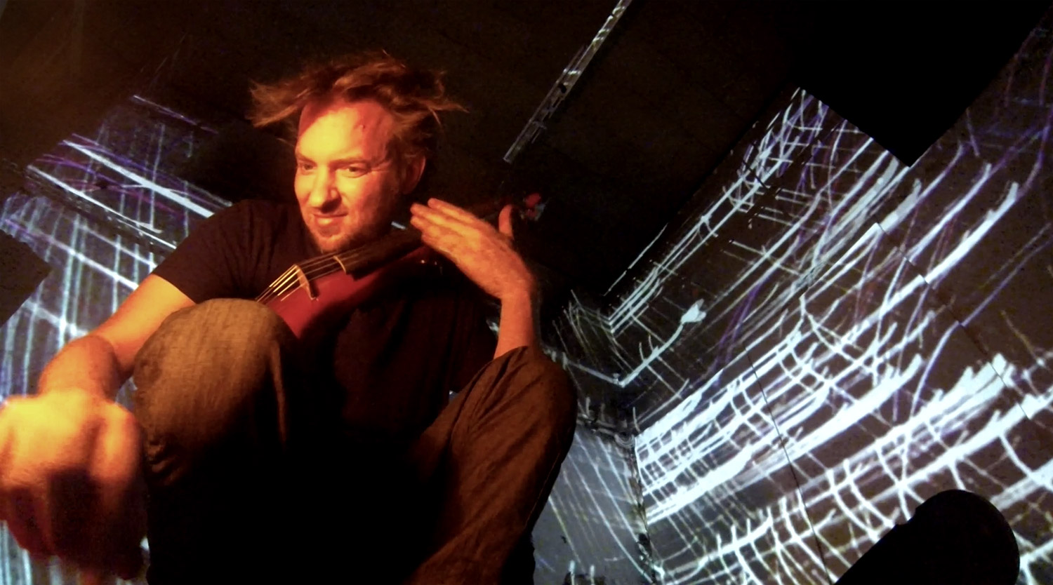 Violinist in front of blue and white line projections – Matthias Jakisic, Vienna, Austria