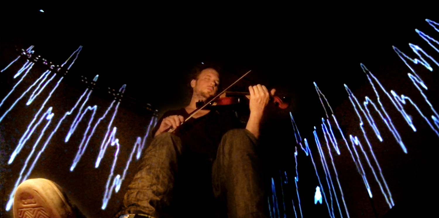 Violinist in front of blue and white line projections – Matthias Jakisic, Vienna, Austria