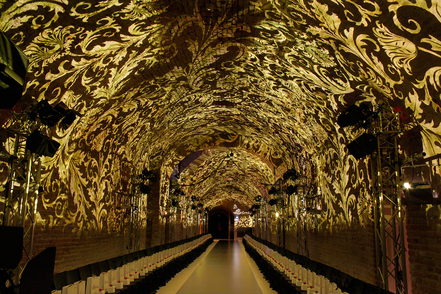 Golden Baroque ornamental projections across the vaulted arches – Solomia Modenschau, Palais Coburg, Vienna, Austria