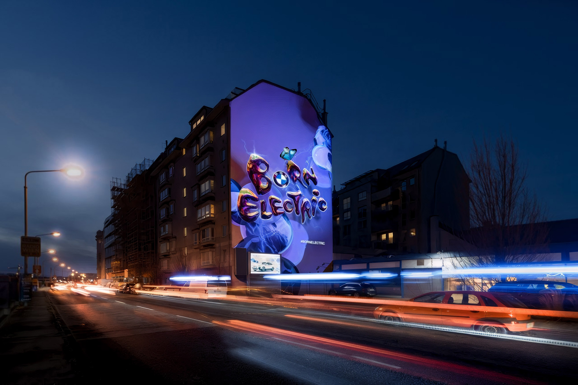 Straßenansicht mit beleuchteter Mural-Projektion und Verkehr – BMW - BORNELECTRIC, Wien, Österreich